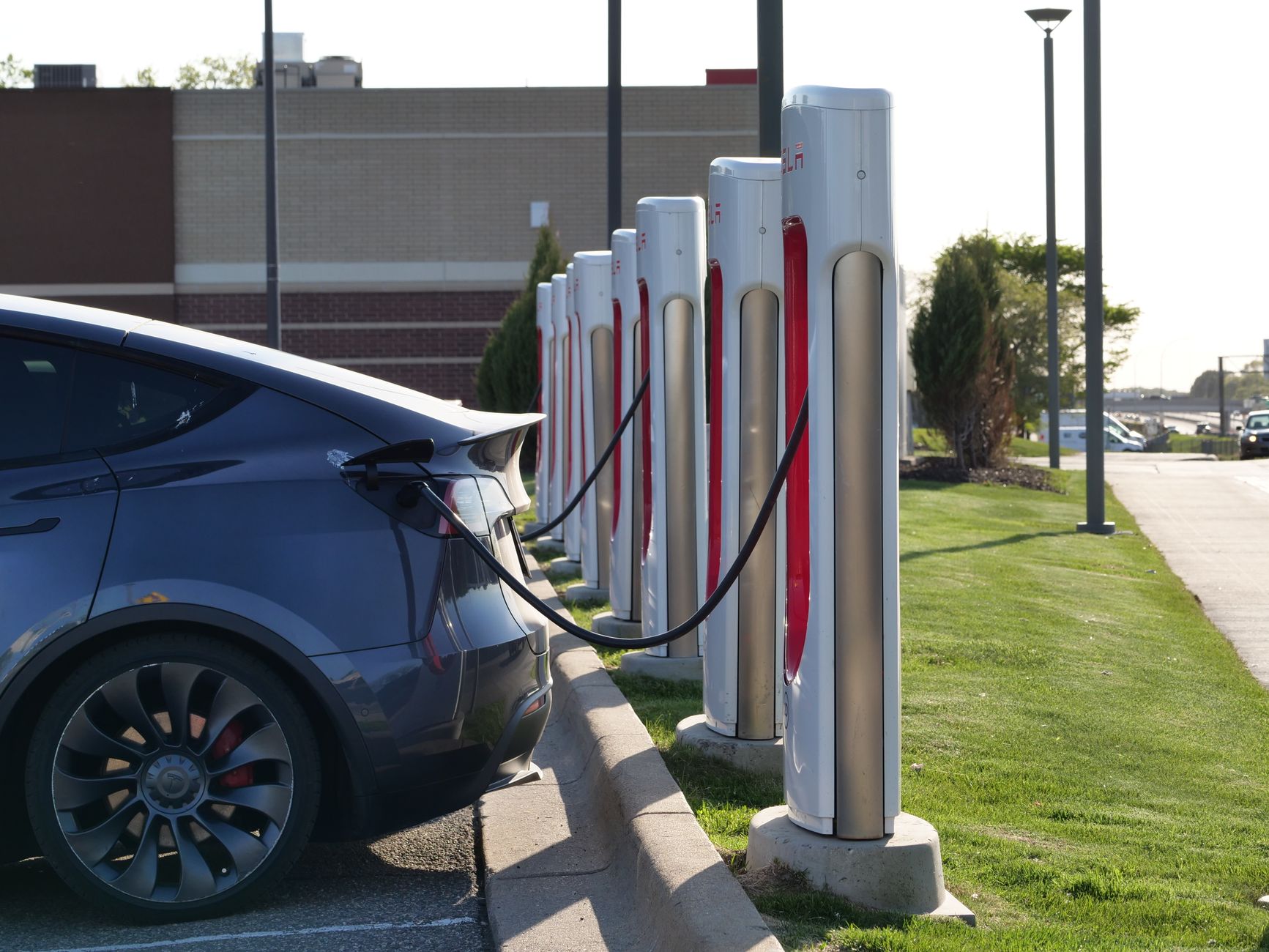 electric car charging at station with multiple chargers